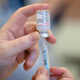 A health care worker preparing a shot of the Moderna booster vaccine.